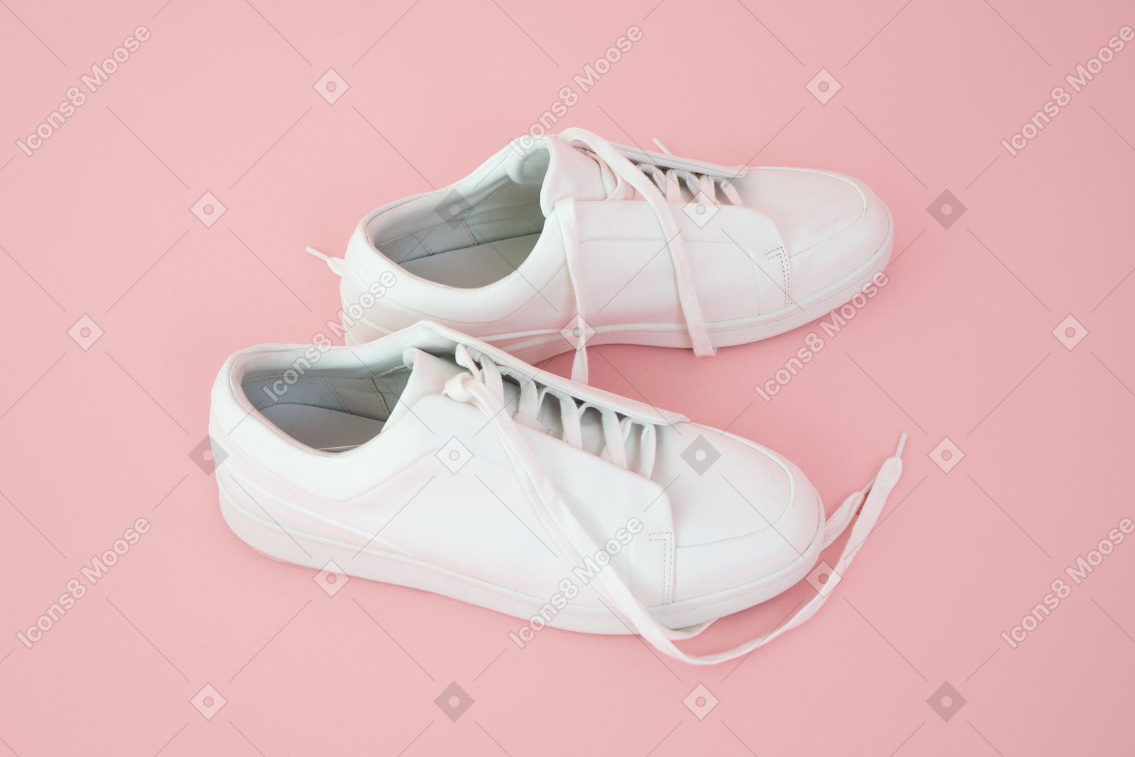 Running shoes over pink background