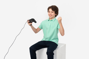 Boy celebrating his win in video game