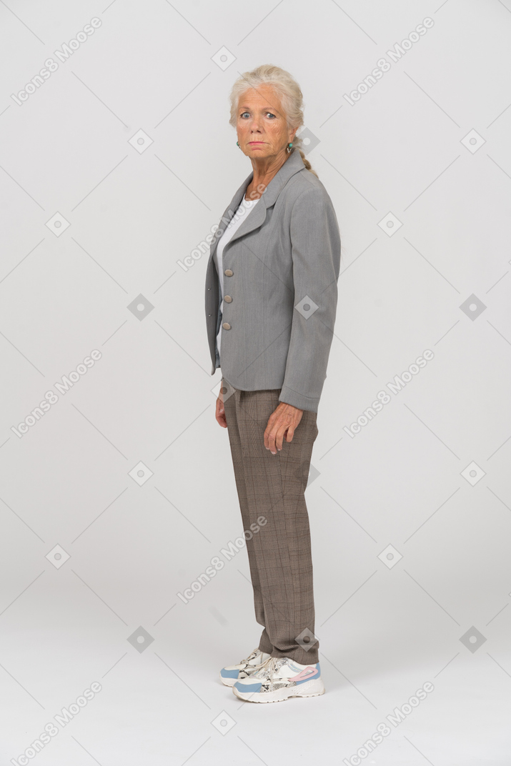 Side view of an old lady in suit staring at something