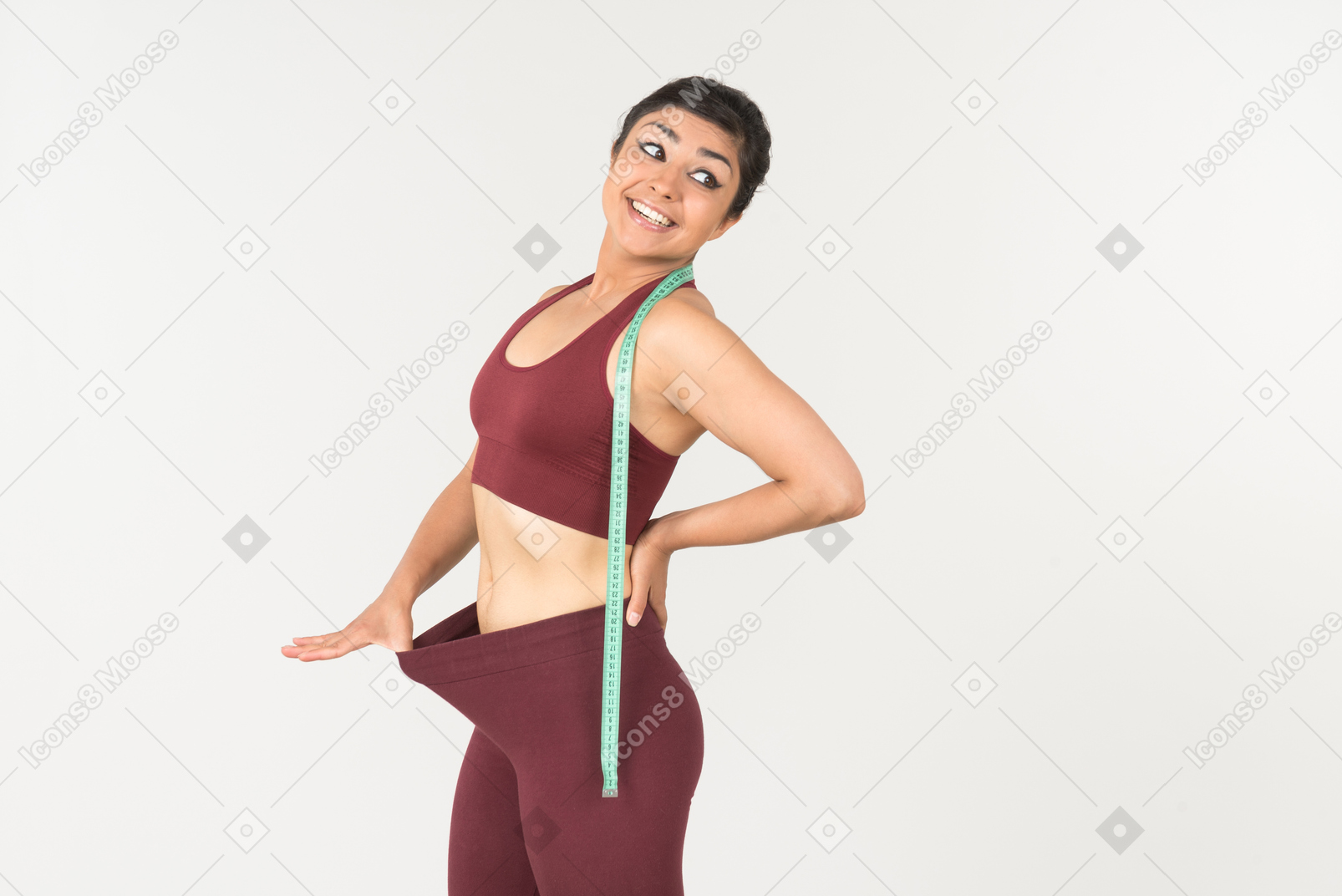 Young indian pulling off sports leggins with cloth ruler on her neck