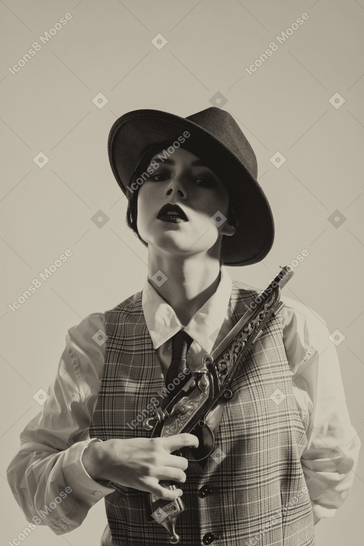A woman wearing a hat and holding a gun