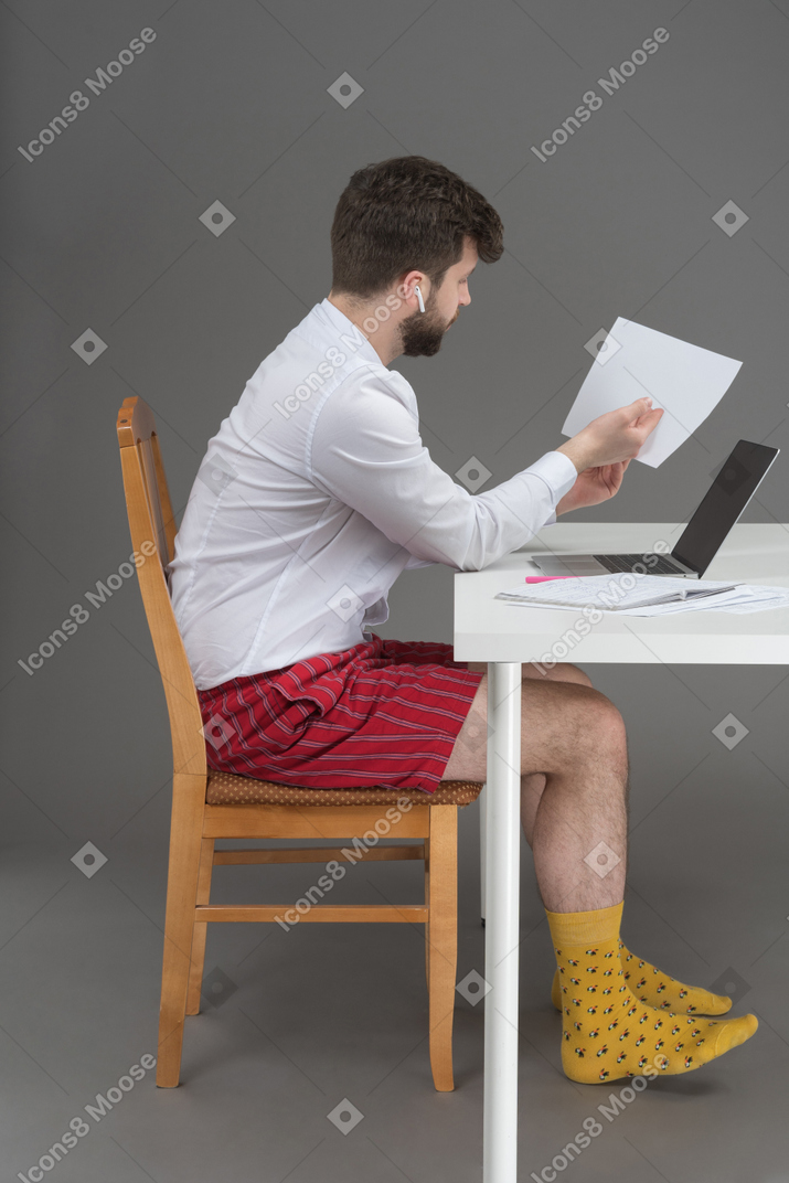 Young man working hard at home office