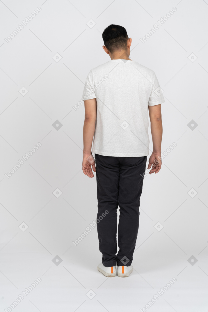 Back view of a man in casual clothes looking aside