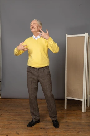 Front view of a gesticulating pleased old man