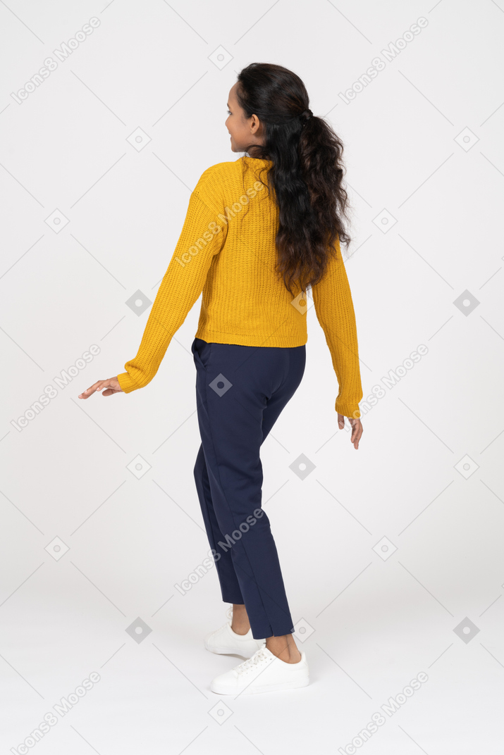 Rear view of a girl in casual clothes looking up