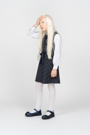 Schoolgirl looking annoyed with hand on forehead