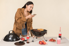 Young asian girl having problem with barbecue