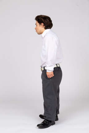 Side view of a young office worker looking down