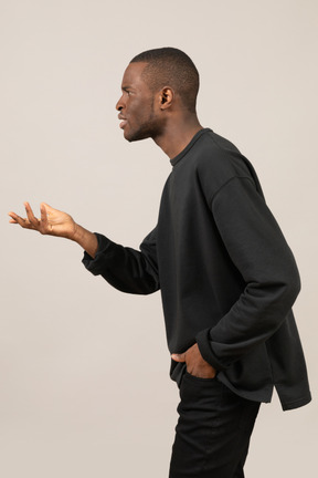 Side view of young man having conversation