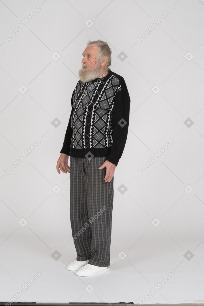 Startled old man standing with arms at side