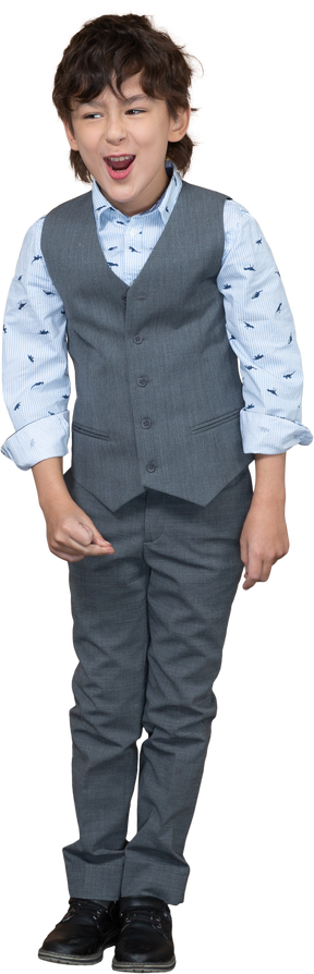 Front view of a happy boy in grey suit looking at camera