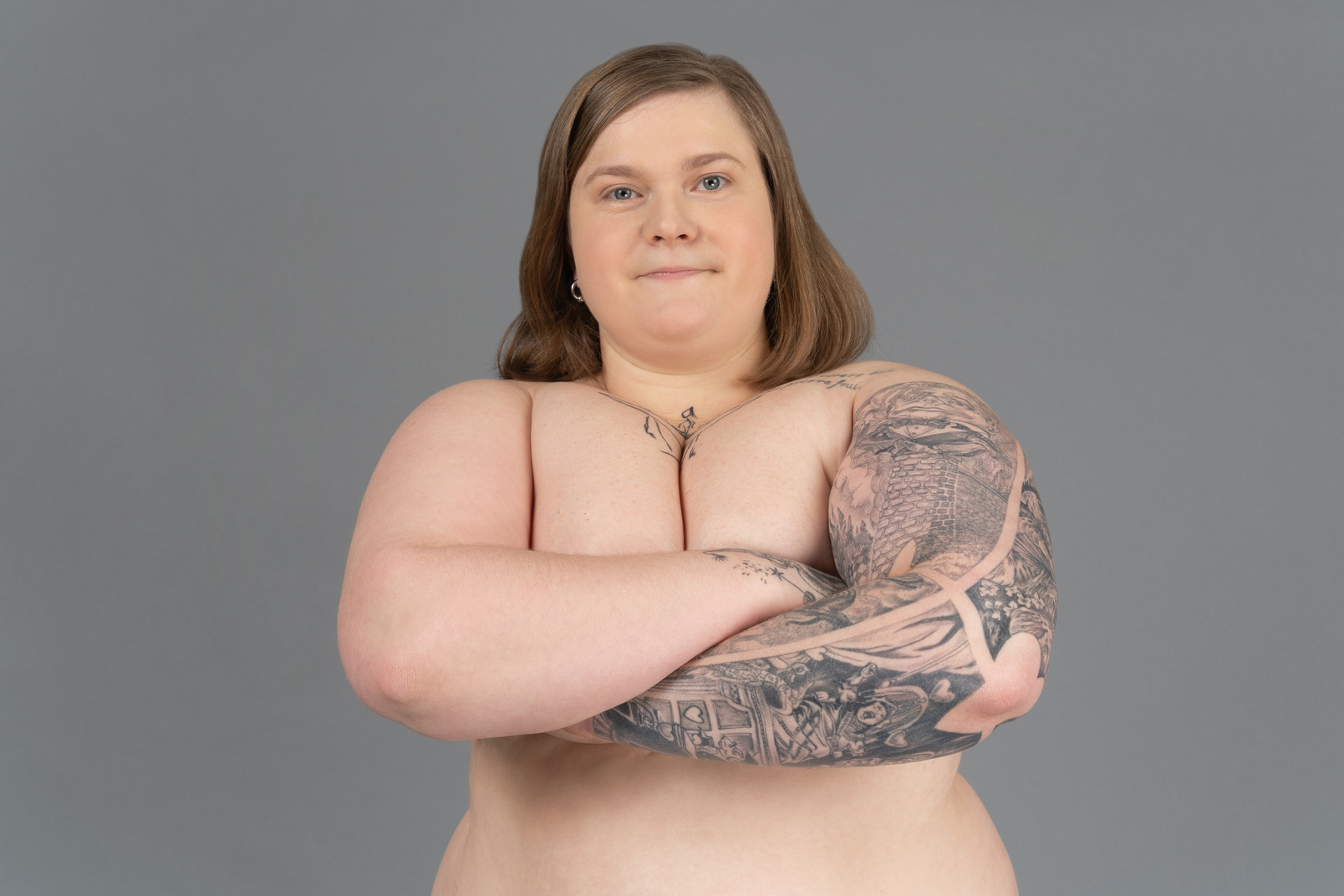 Plus size woman standing with her arms crossed