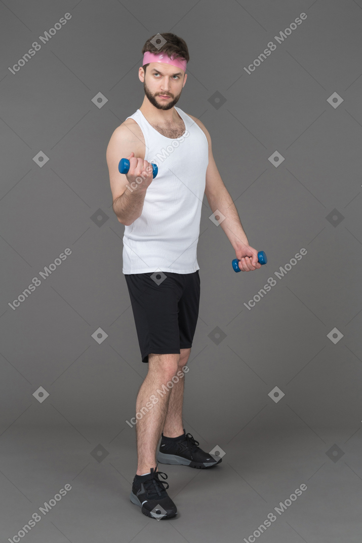 Man lifting blue dumbbells
