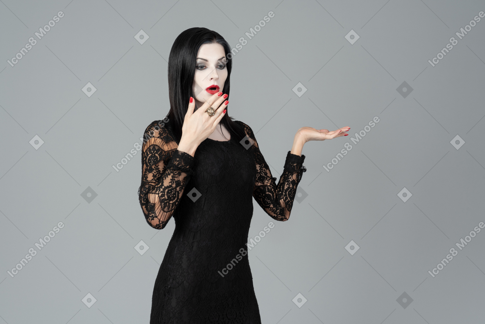 Morticia addams gasping and covering her face with hand a little