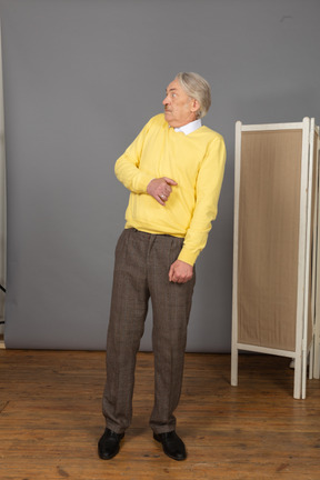 Three-quarter view of an old scared man leaning back