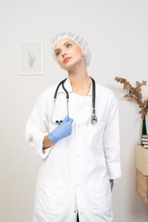 Front view of a young female doctor holding stethoscope