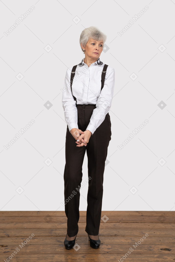 Vista frontal de uma senhora com roupa de escritório, de mãos dadas