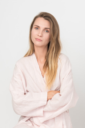 Beautiful young woman in a pink robe