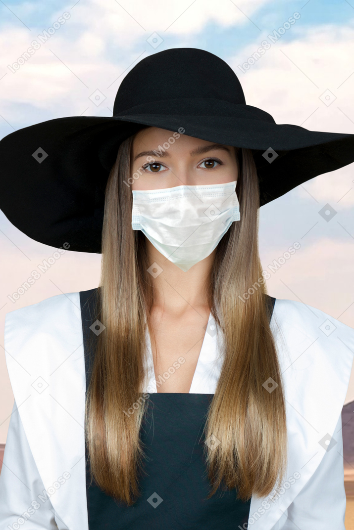 Woman wearing a hat and face mask