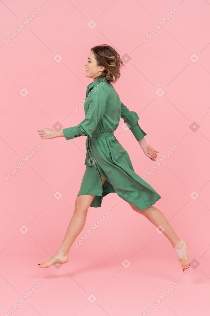 Young woman walking sideways