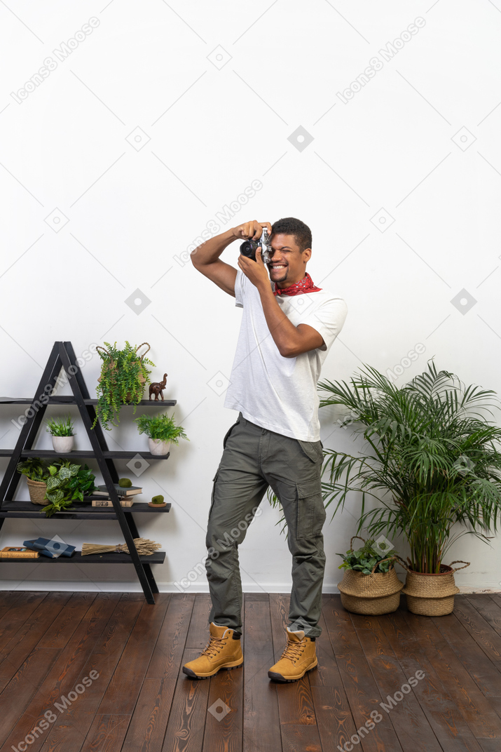 Good looking young man with a camera