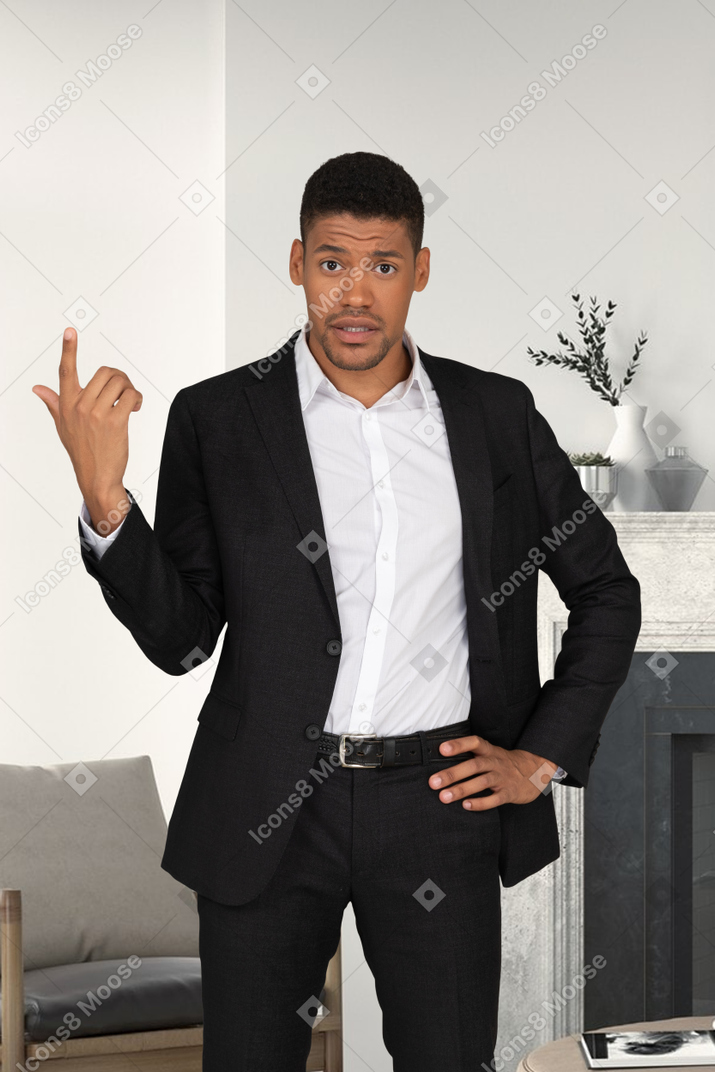 Man in a suit pointing up