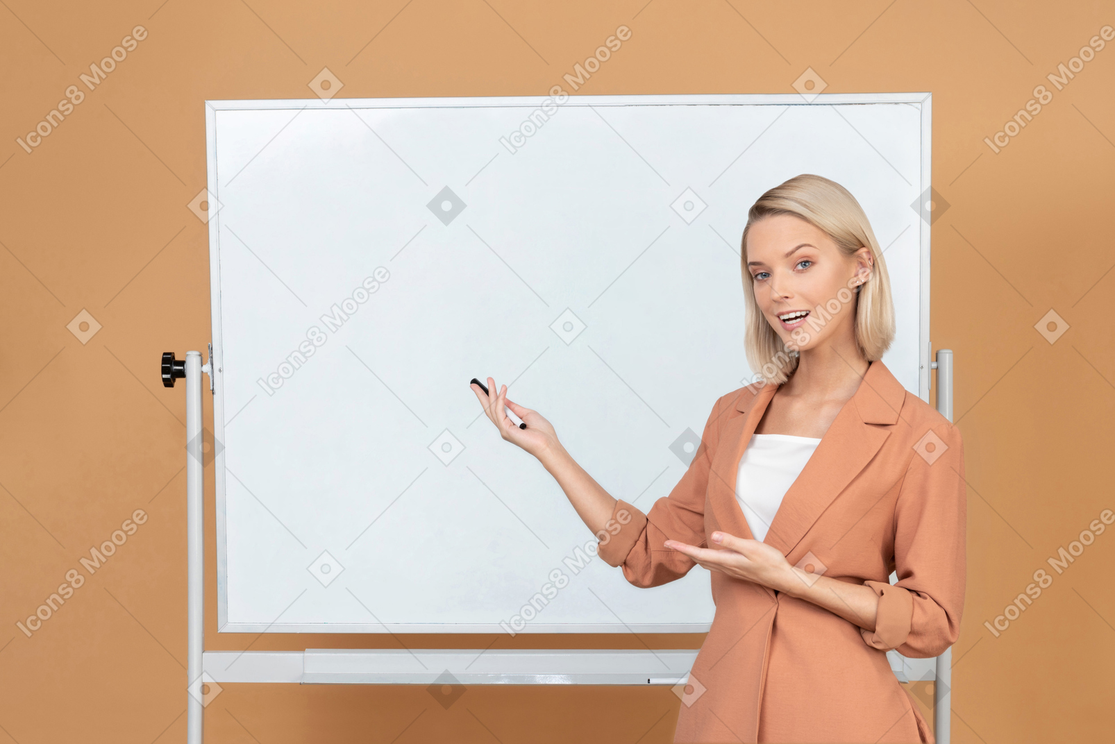 Attractive woman standing next to a whiteboard and explaining something