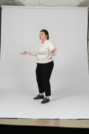 Side view of a plump woman in casual clothes gesturing