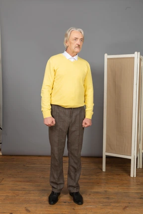 Front view of a serious old man looking aside