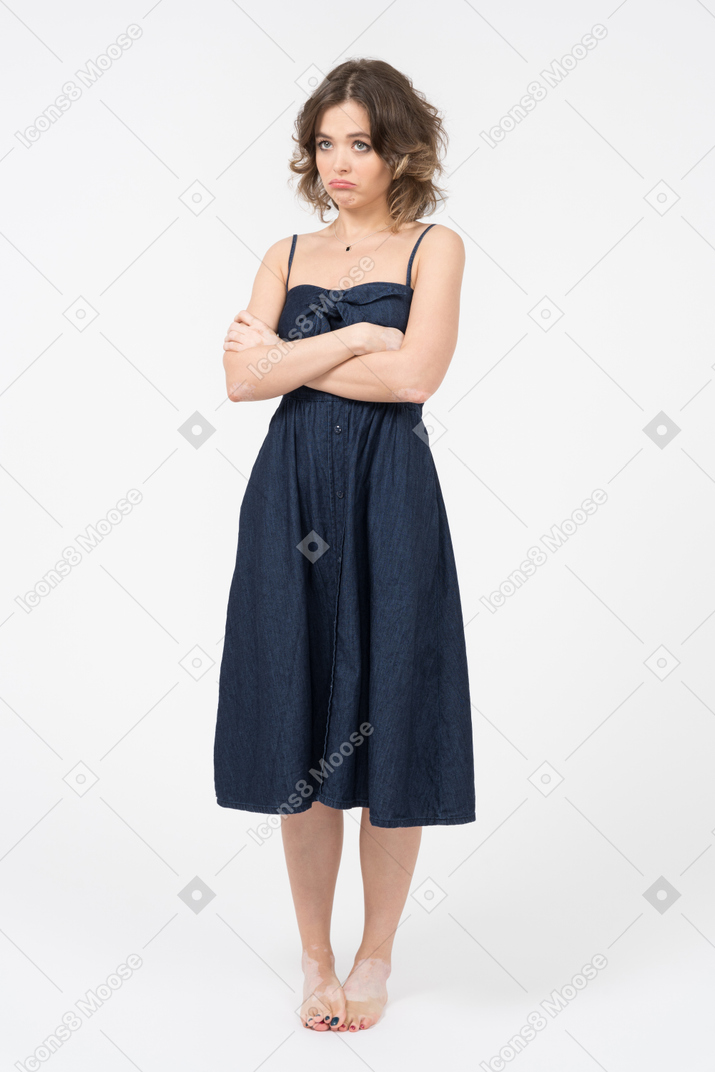 Serious young woman holding arms crossed on her chest