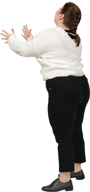 Happy plus size woman in white sweater