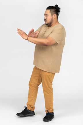 Serious asian man making x sign gesture with both hands