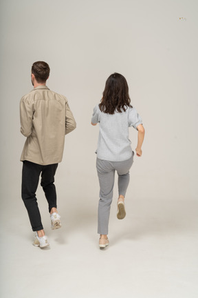 Back view of two people running