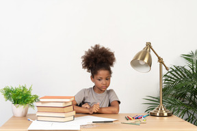 Good looking cute girl with books at the table