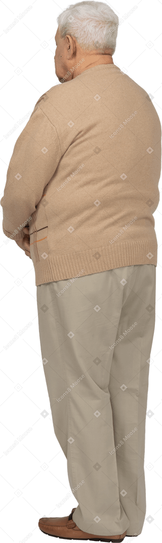 Rear view of an old man in casual clothes standing still