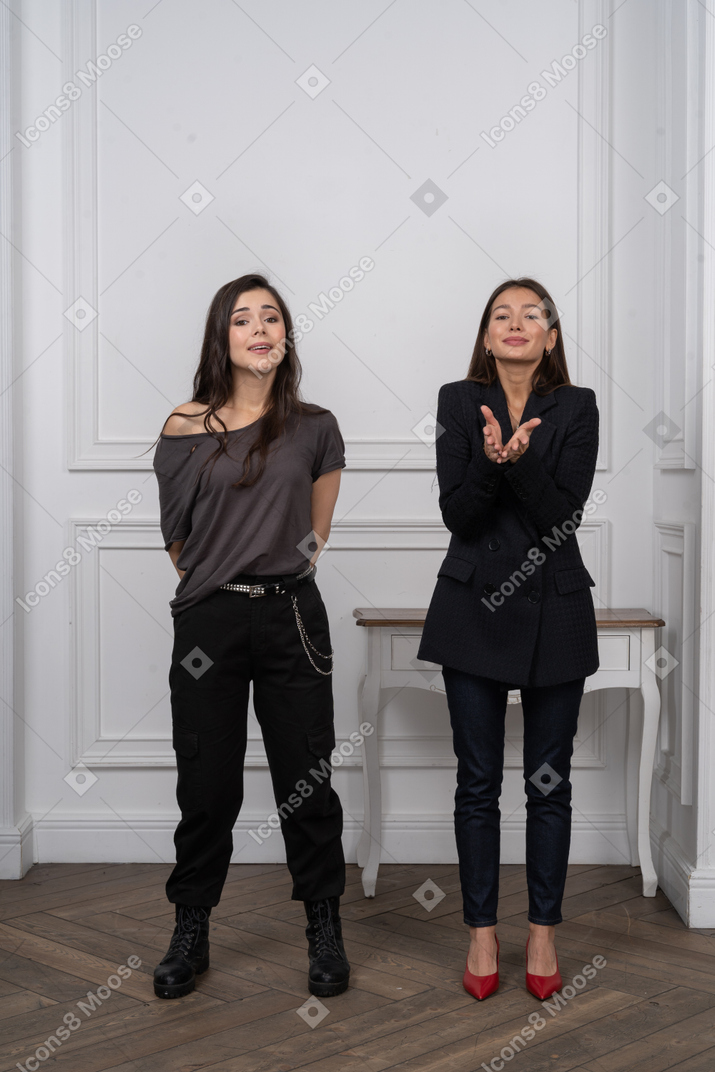 Two smiling women standing in a room