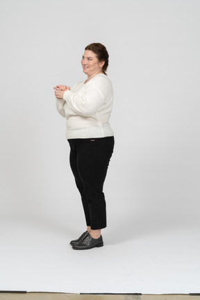 Side view of a happy plus size woman in casual clothes