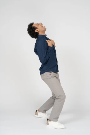 Side view of a man in casual clothes looking up