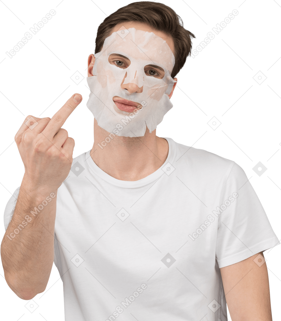 Front view of a young man in facial mask showing middle fingers