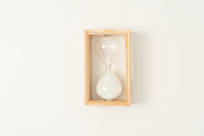 Wooden hourglass on a white background