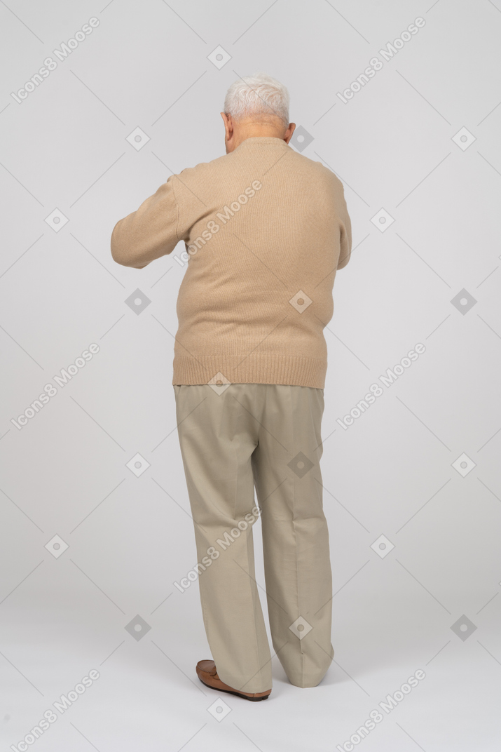 Rear view of an old man in casual clothes explaining something