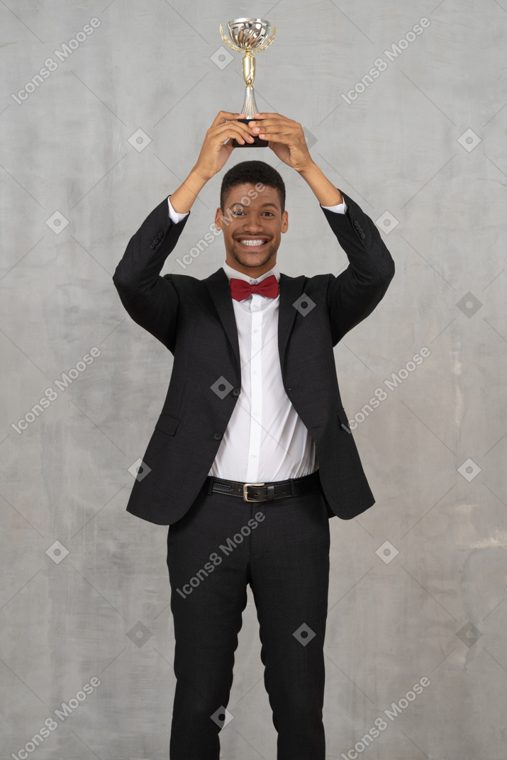 Man holding up award in celebration of his win