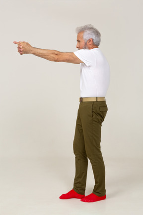 Man in casual clothes aiming a finger gun