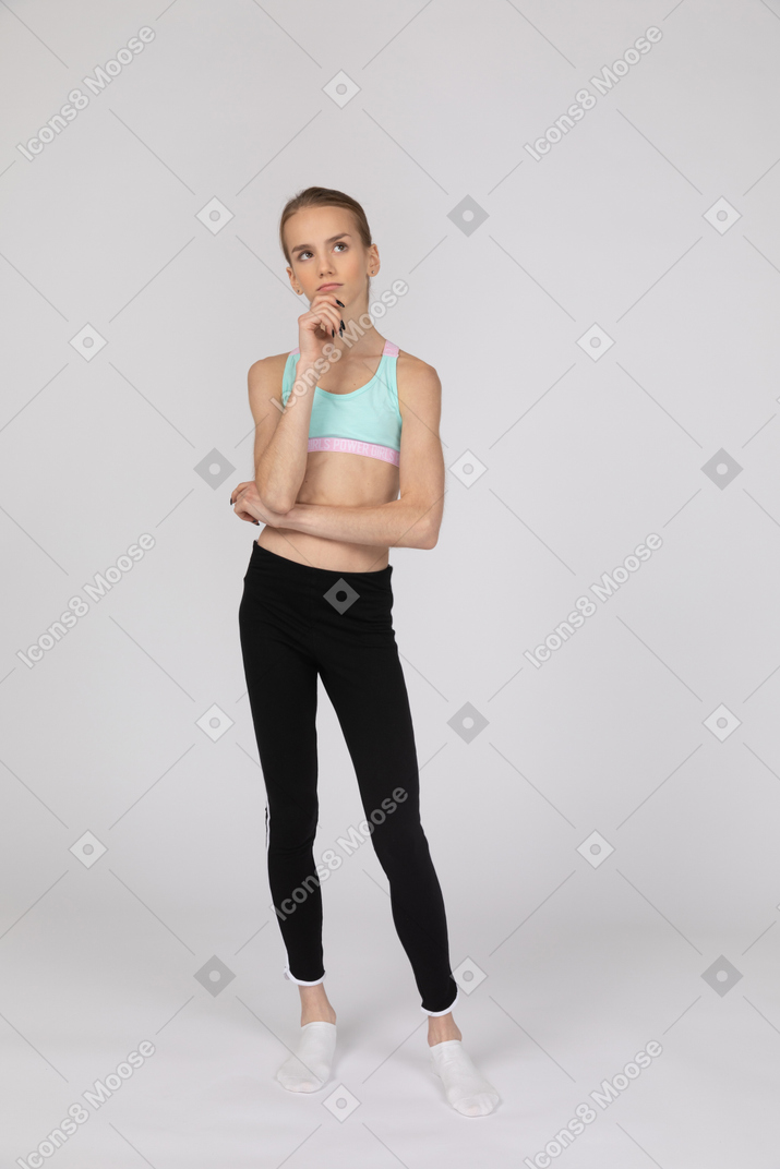 Pensive teen girl in sportswear