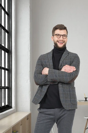 A man standing in a room with his arms crossed