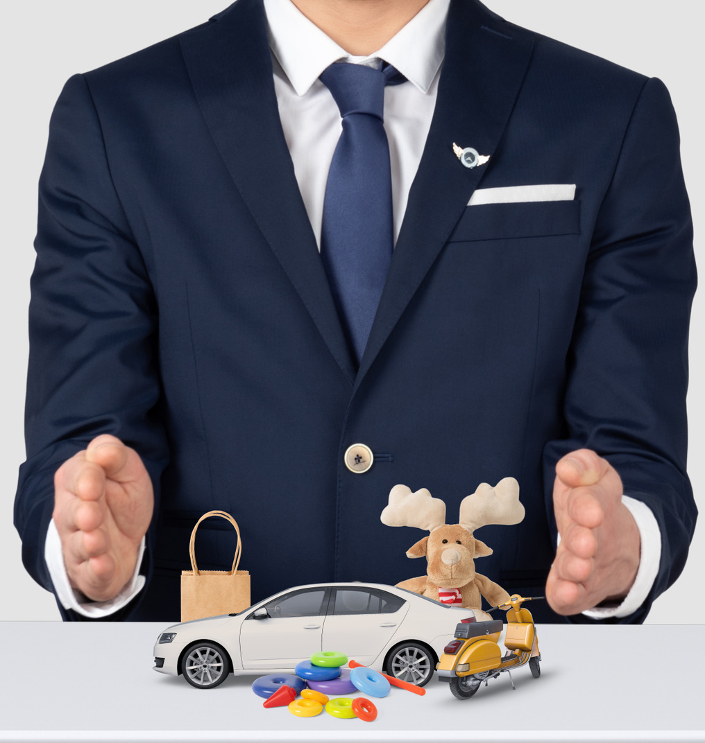 A man in a suit holding a toy car