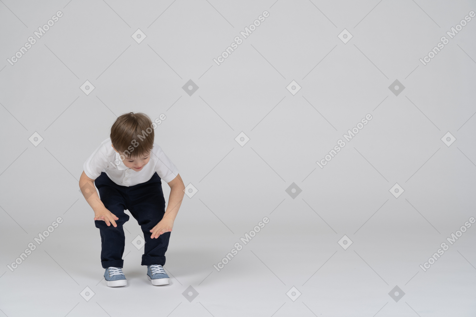 Little boy in casual clothes bending forward