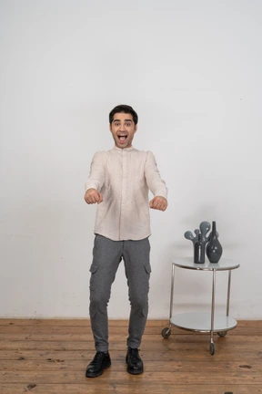 Happy man in shirt looking at camera