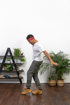 Good looking young man posing on the background of the apartment