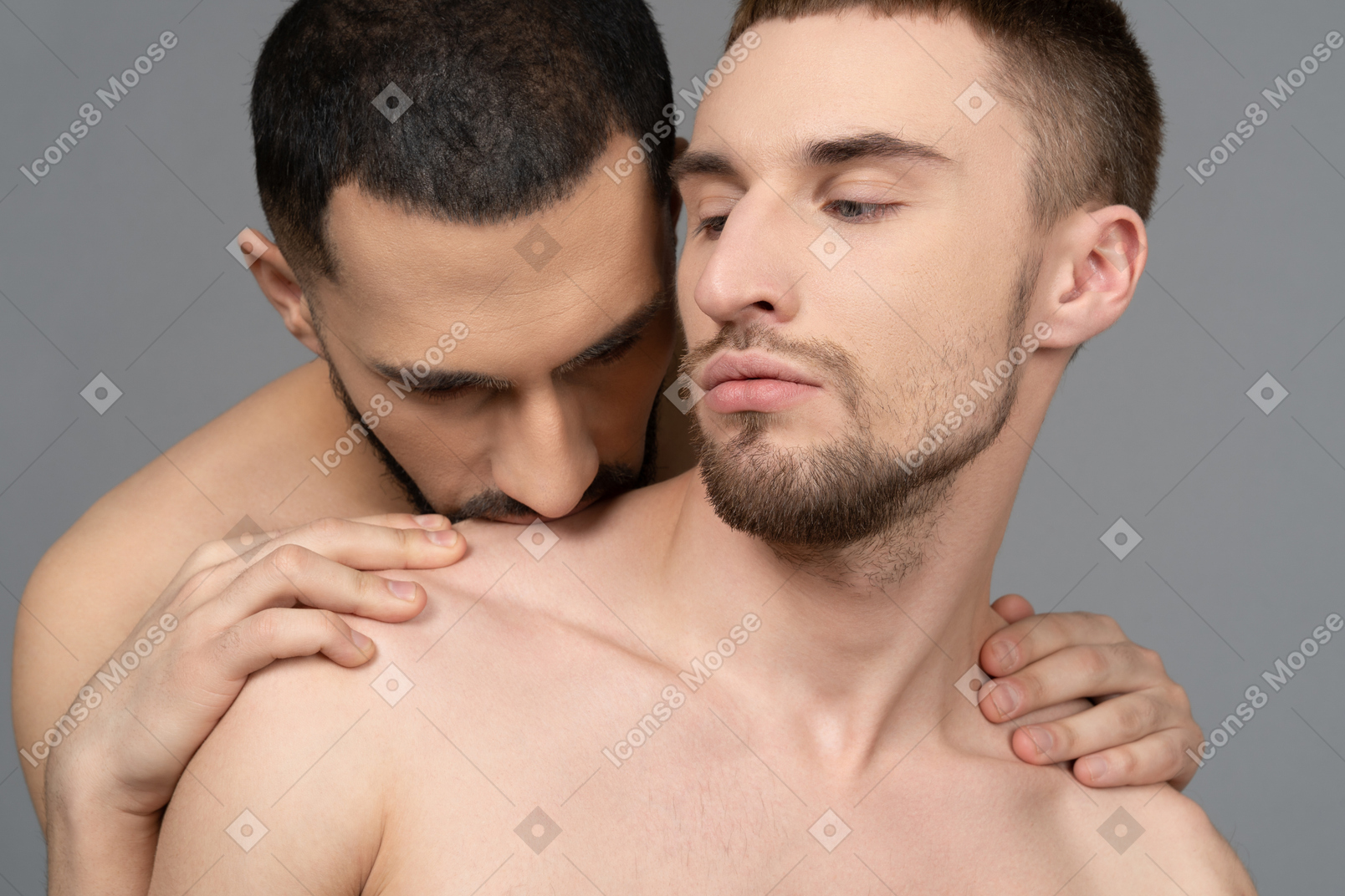 Close-up of a young man kissing boyfriend's shoulder